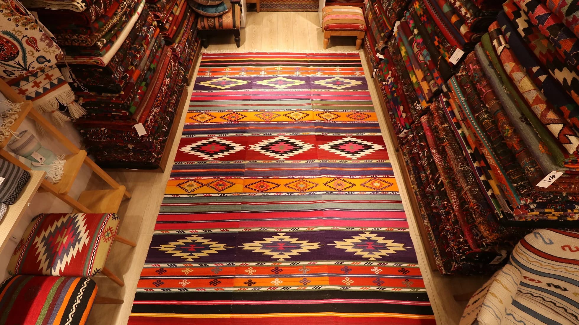 vibrant, vivid, and colorful striped Anatolian Turkish rug hand-knotted in the mid-century in traditional patterns
