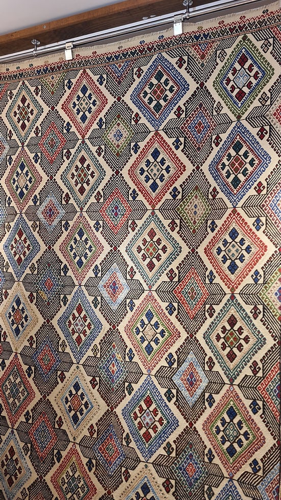 5x7 Handwoven Turkish Kilim rug showcasing timeless Anatolian motifs, with a sophisticated color palette of ivory, crimson, indigo, and faded linen.