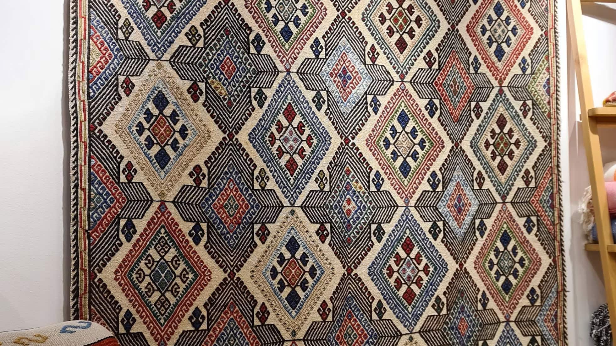 Rare authentic handwoven rug with geometric diamond shapes, perfect for collectors and interior designers.