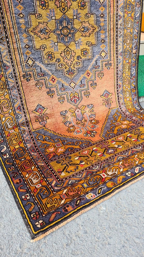 Mid-century Yahyali rug from Kayseri, Turkey, 3x7 ft, handwoven with 100% wool. Features a soft dusty peach background with a central floral medallion in powder blue and gold, surrounded by delicate floating motifs and a triple floral border. Crafted using natural dyes from madder root and walnut shells, showcasing traditional Turkish artistry and durable craftsmanship.