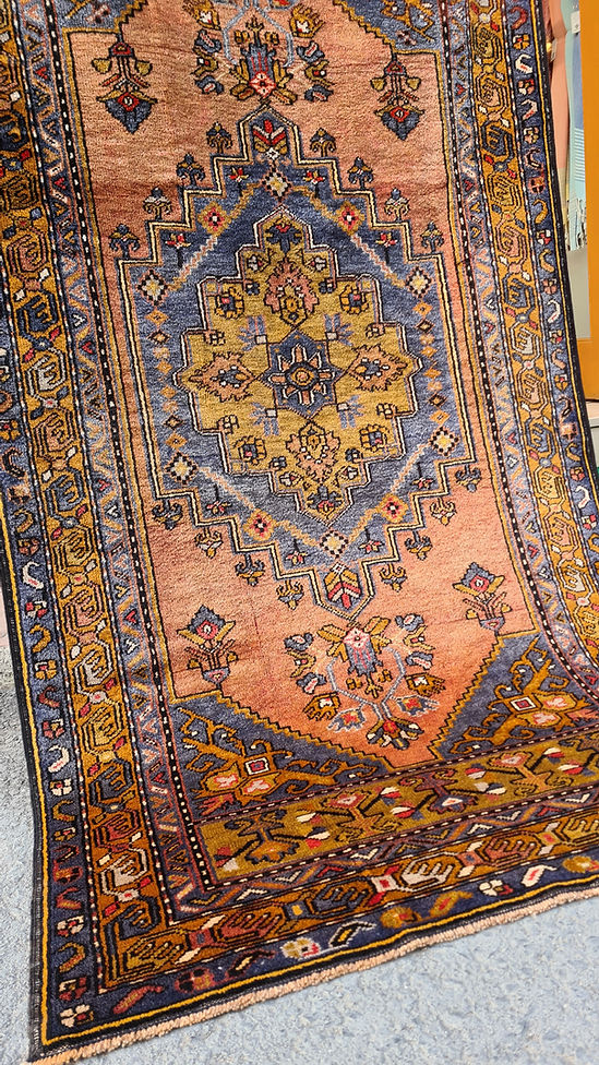 Mid-century Yahyali rug from Kayseri, Turkey, 3x7 ft, handwoven with 100% wool. Features a soft dusty peach background with a central floral medallion in powder blue and gold, surrounded by delicate floating motifs and a triple floral border. Crafted using natural dyes from madder root and walnut shells, showcasing traditional Turkish artistry and durable craftsmanship.