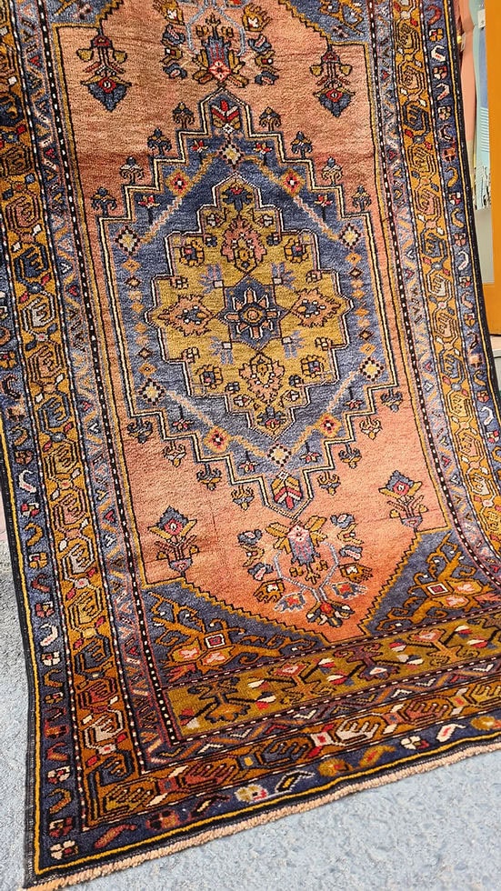 Mid-century Yahyali rug from Kayseri, Turkey, 3x7 ft, handwoven with 100% wool. Features a soft dusty peach background with a central floral medallion in powder blue and gold, surrounded by delicate floating motifs and a triple floral border. Crafted using natural dyes from madder root and walnut shells, showcasing traditional Turkish artistry and durable craftsmanship.