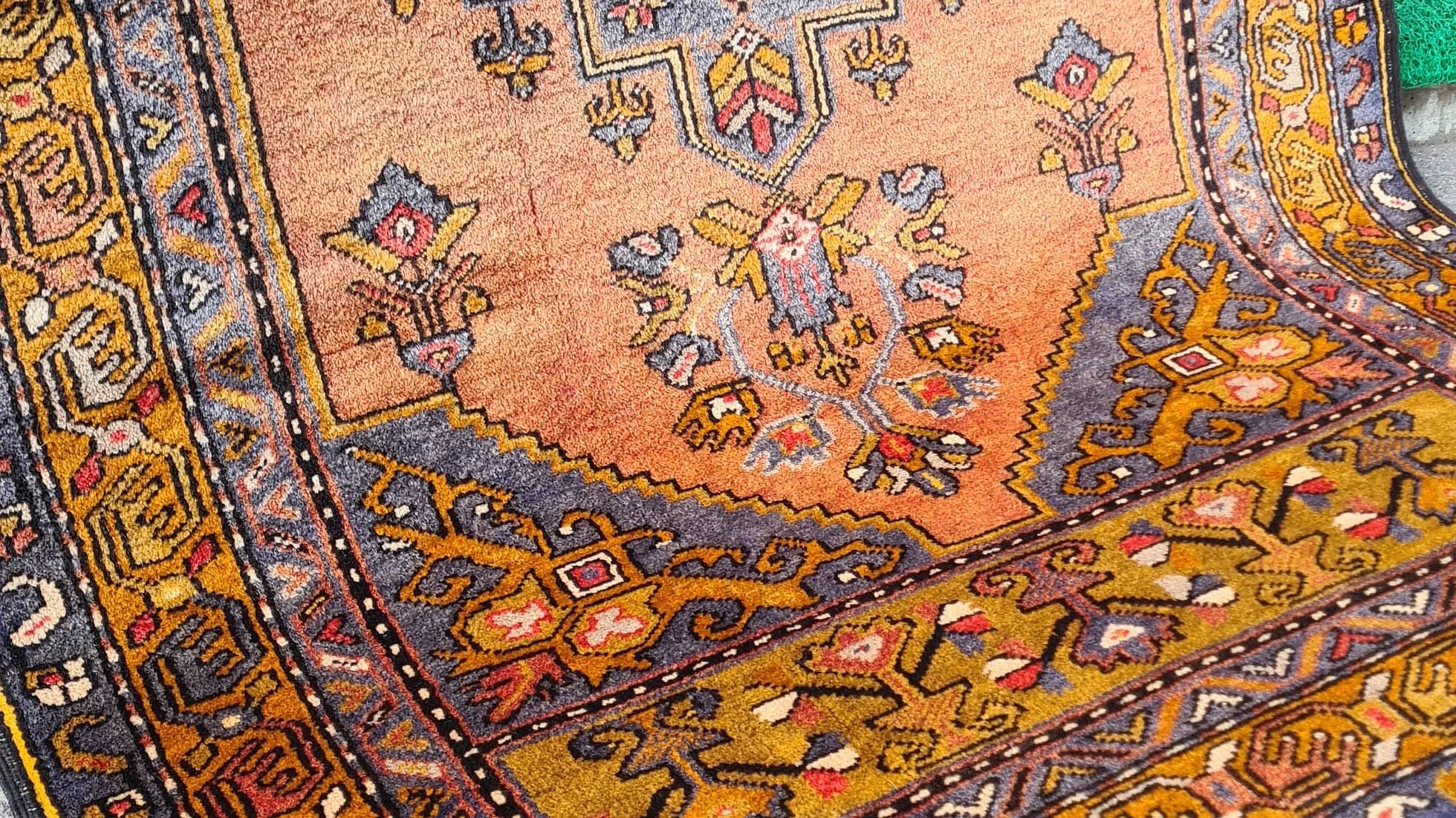 Mid-century Yahyali rug from Kayseri, Turkey, 3x7 ft, handwoven with 100% wool. Features a soft dusty peach background with a central floral medallion in powder blue and gold, surrounded by delicate floating motifs and a triple floral border. Crafted using natural dyes from madder root and walnut shells, showcasing traditional Turkish artistry and durable craftsmanship.