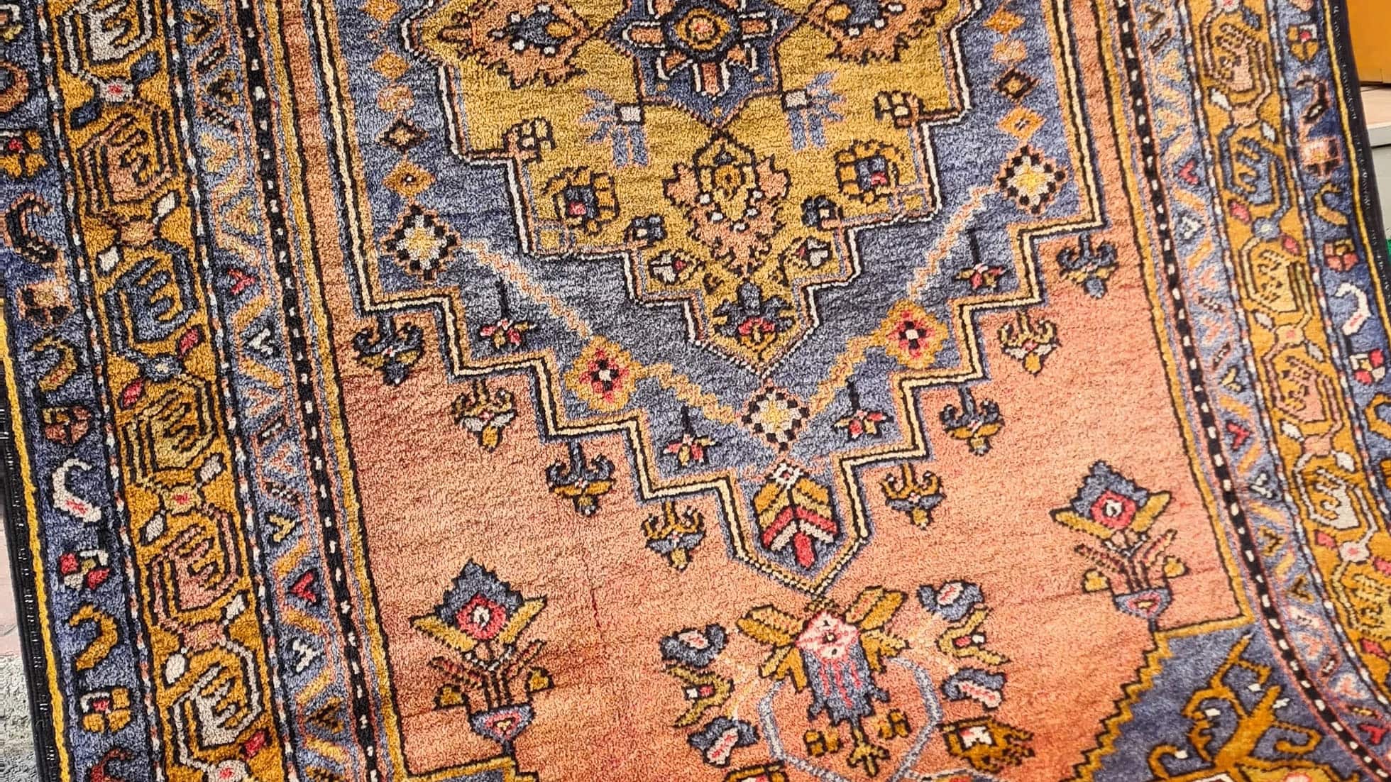 Mid-century Yahyali rug from Kayseri, Turkey, 3x7 ft, handwoven with 100% wool. Features a soft dusty peach background with a central floral medallion in powder blue and gold, surrounded by delicate floating motifs and a triple floral border. Crafted using natural dyes from madder root and walnut shells, showcasing traditional Turkish artistry and durable craftsmanship.