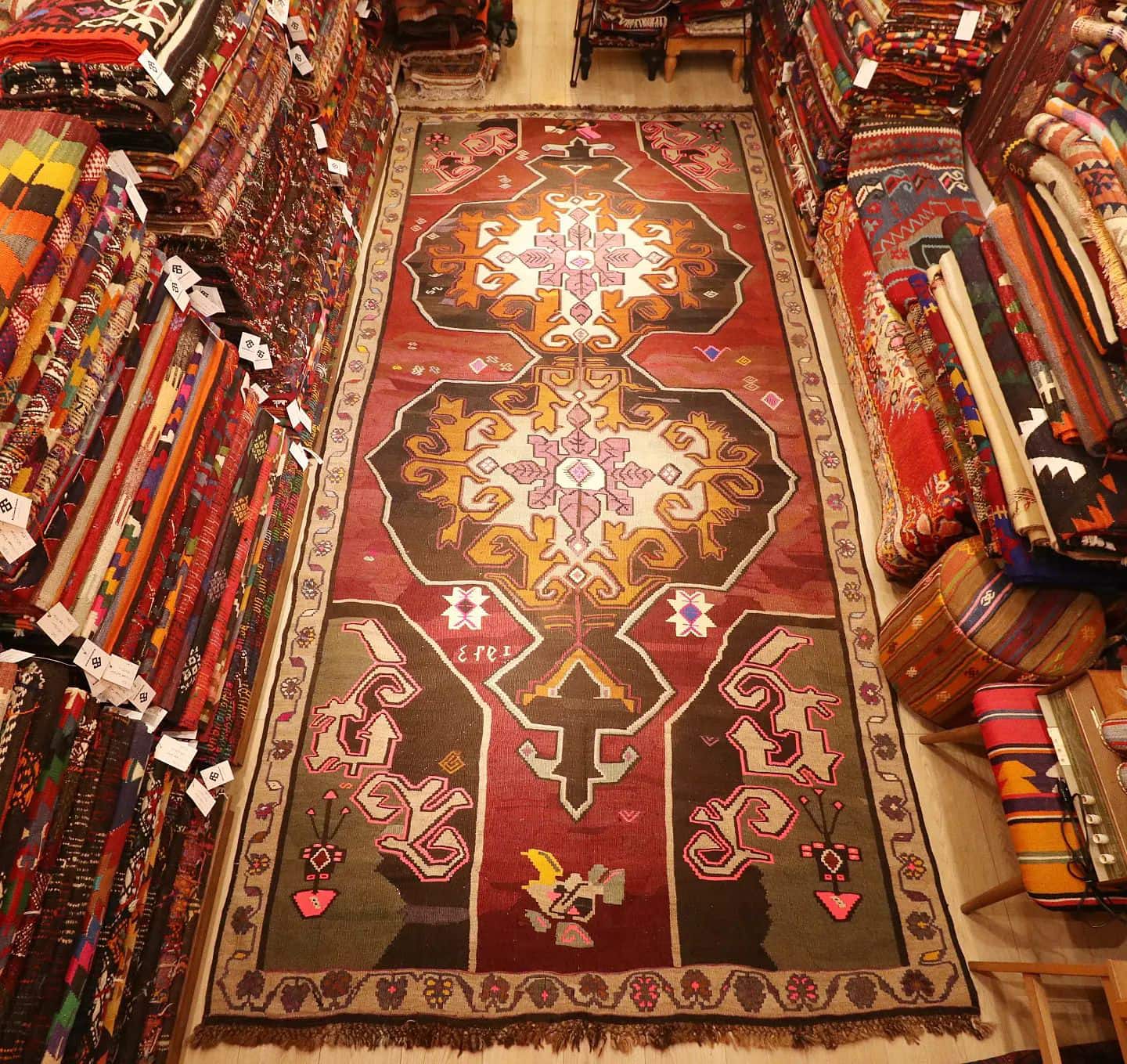 vintage handwoven runner rug with date signature and medallions in floral border