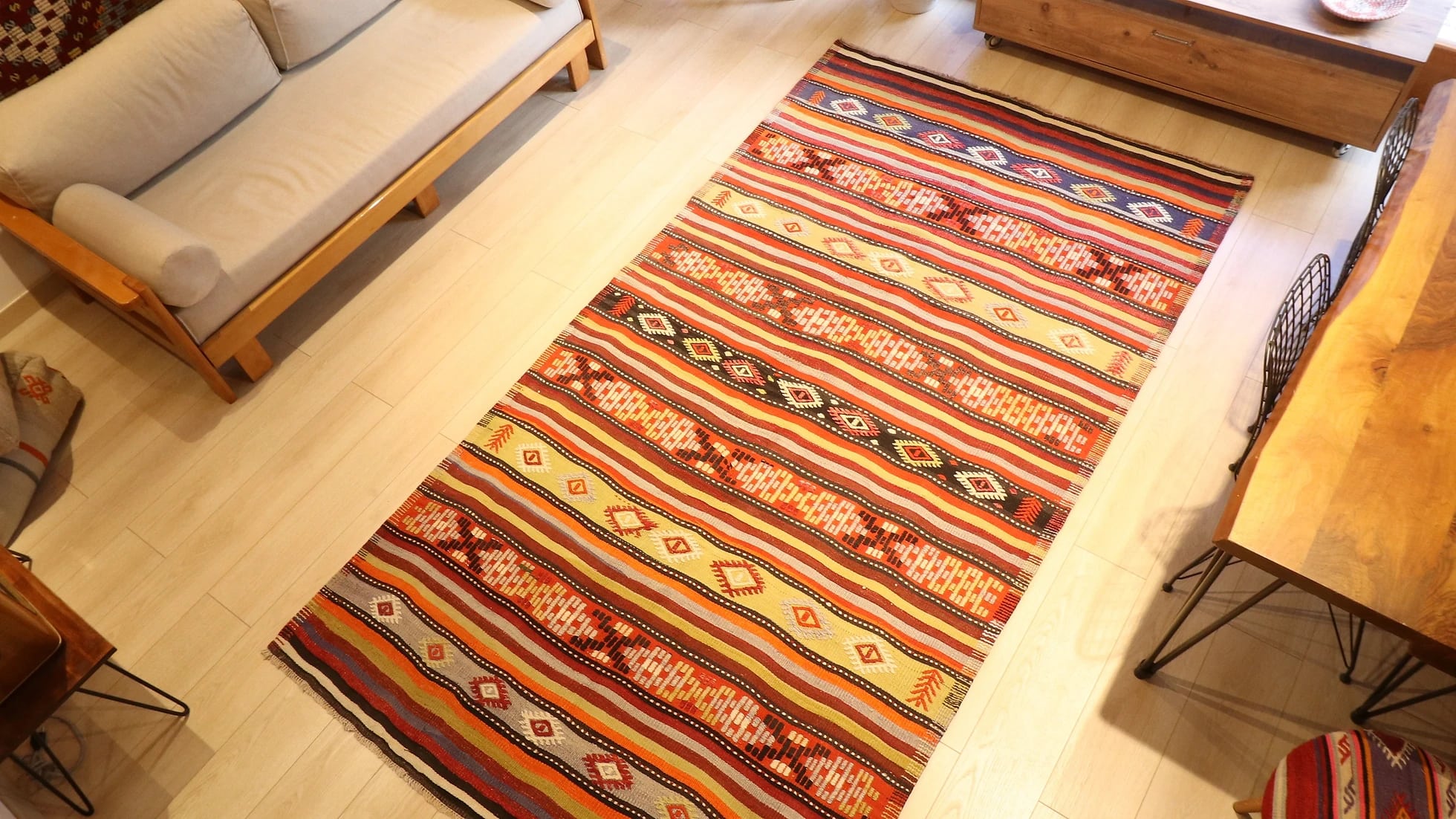 an old vintage handwoven Turkish runner rug in natural rustic hues and traditional stripe patterns