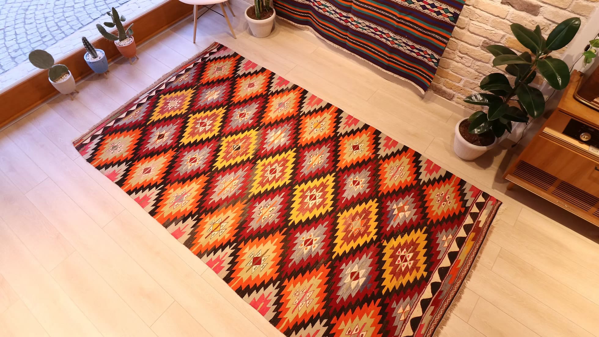 5'4" x 9'4" Afyon Vintage Turkish Kilim Rug showcasing a luxurious Velvet Onyx backdrop and Desert Ivory accents