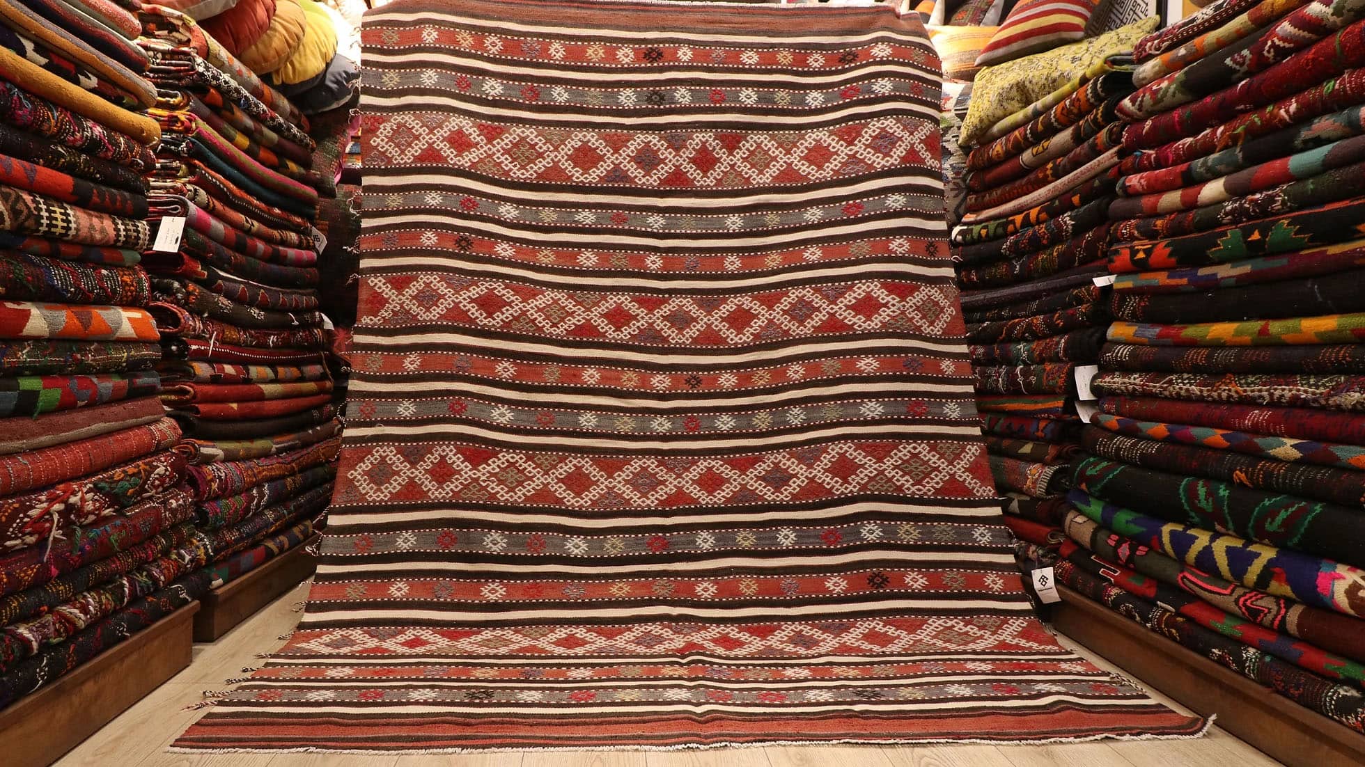 a magnificent and true authentic striped Turkish kilim rug in rustic earth tones like terracotta from the 1950s era by KCNY