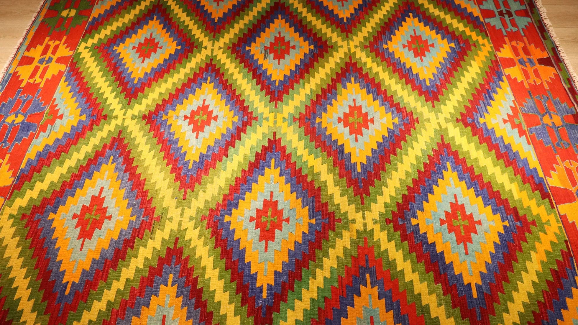 vibrant, vivid, and colorful vintage Turkish rug in geometric patterns woven sustainably in Denizli, Turkey