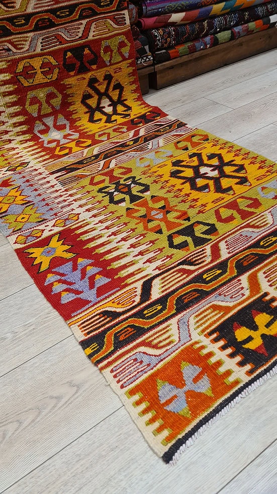 Authentic 1940s Turkish kilim runner, handwoven in vibrant ember red and golden saffron tones, symbolizing protection, prosperity, and clarity in a vintage wool design