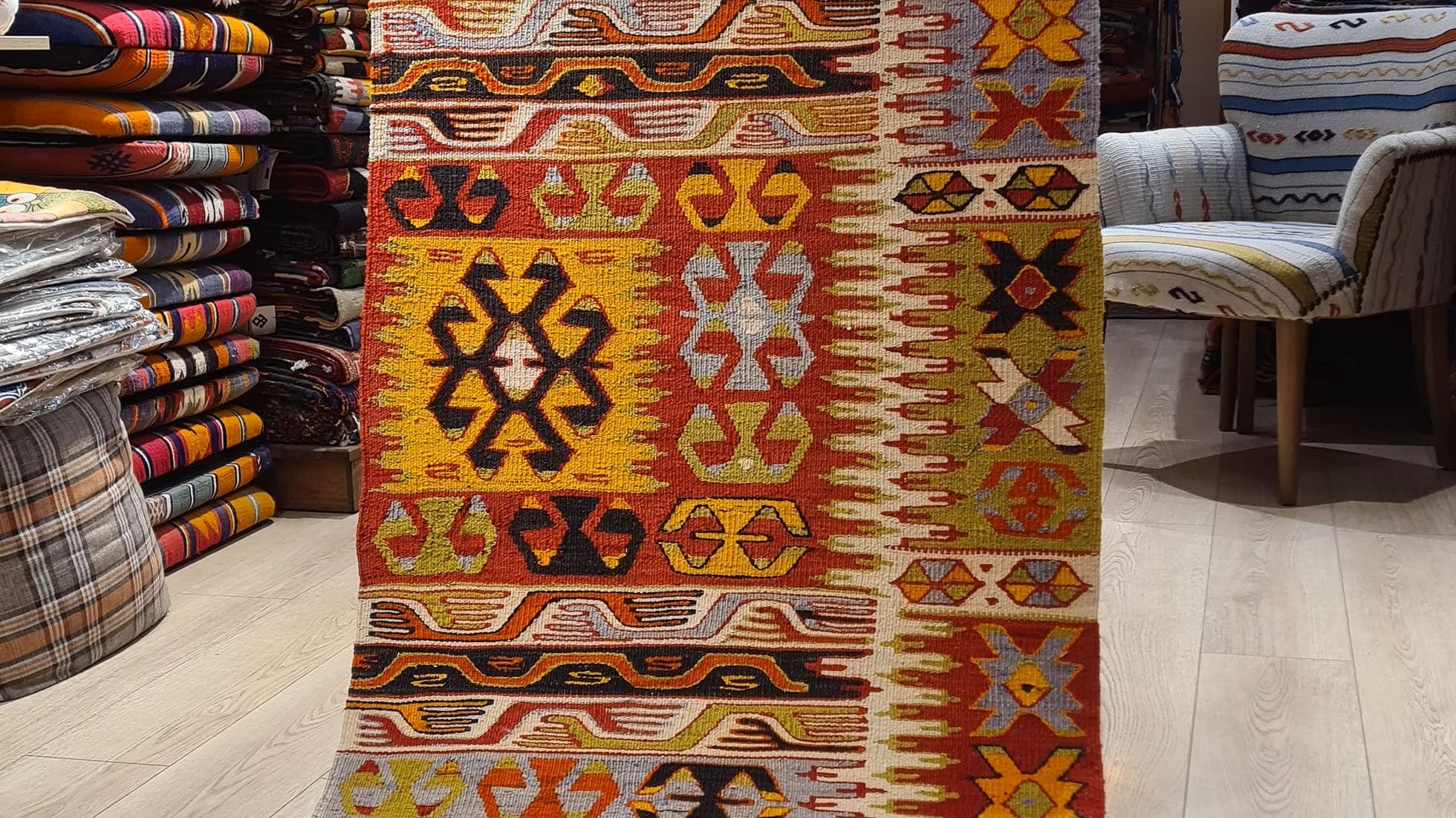 Handwoven Turkish kilim from Denizli, featuring rich colors and ancestral patterns, a 1940s flat-woven masterpiece ideal for traditional or minimalist hallways