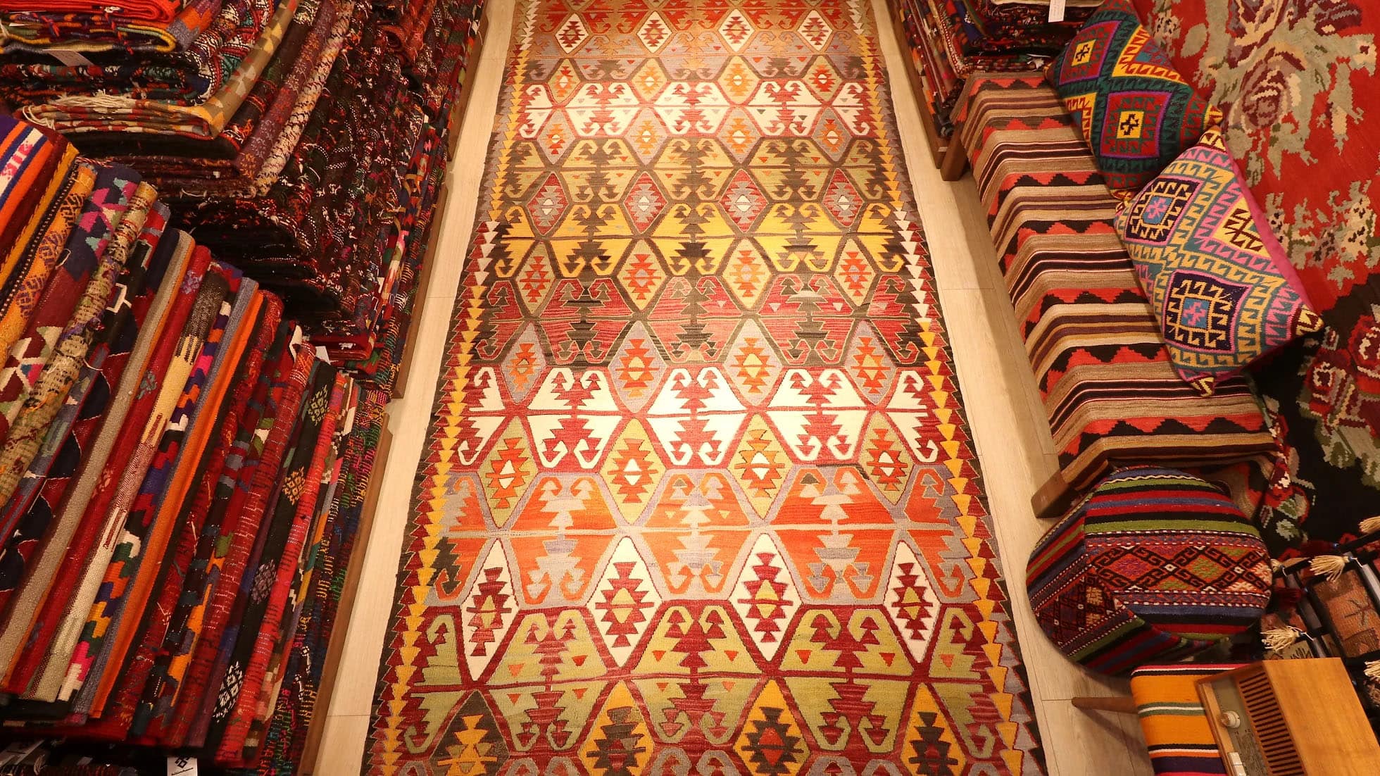 Kilim Couture New York Handwoven Vintage Turkish Kilim Rug from Konya, 1950s – "Hands on Hips" Anatolian Motif with Geometric "Running Water" Border in Terracotta, Mustard, and Taupe Tones.