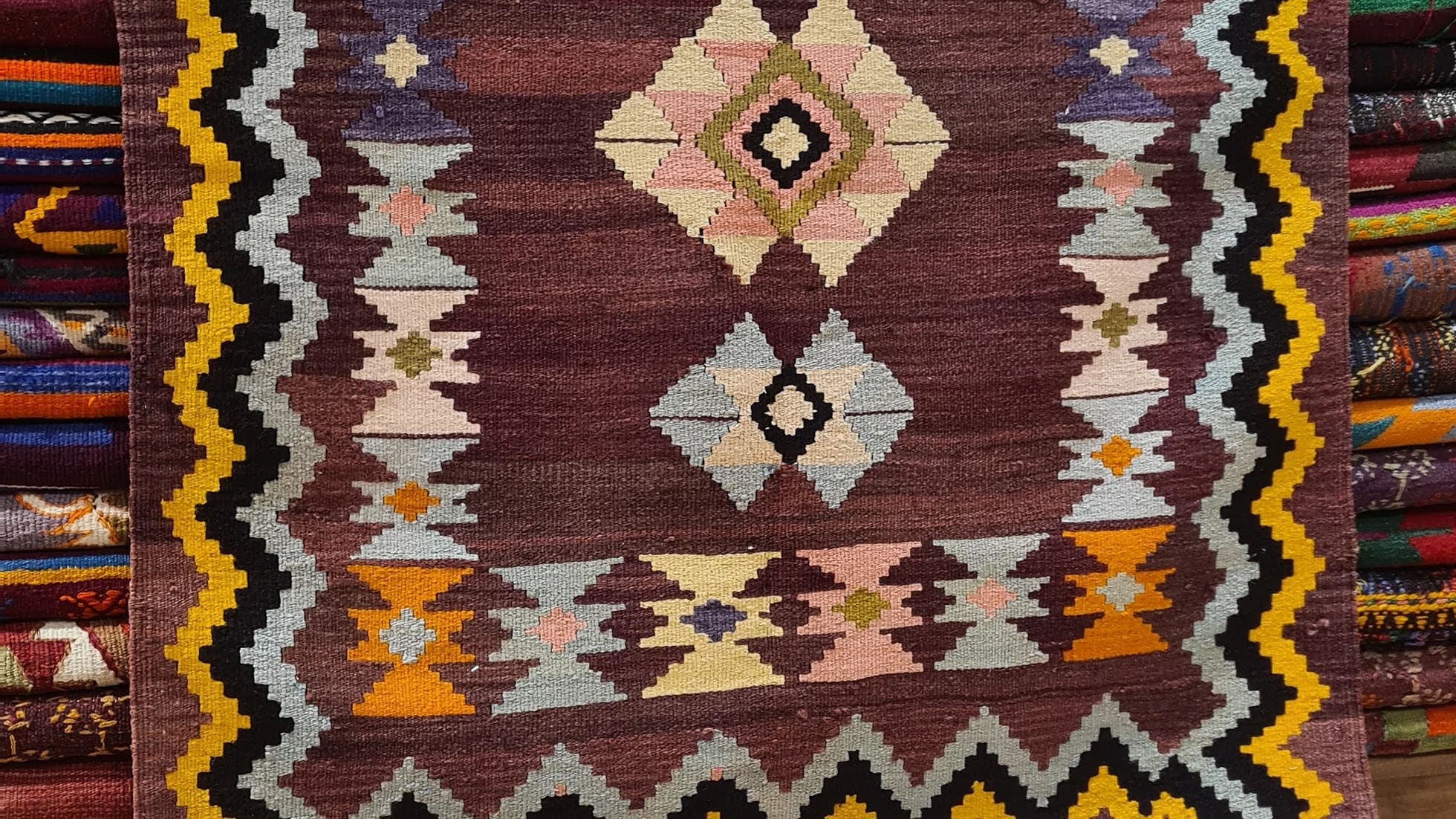 Vintage Handwoven Milas Kilim Rug, 4x5 ft, featuring a mocha mousse background with muted tones of rosewater pink, lavender mist, and tangerine peel. Adorned with intricate 'hair band' and 'running water' motifs, this artisan-crafted piece blends heritage and sophistication.