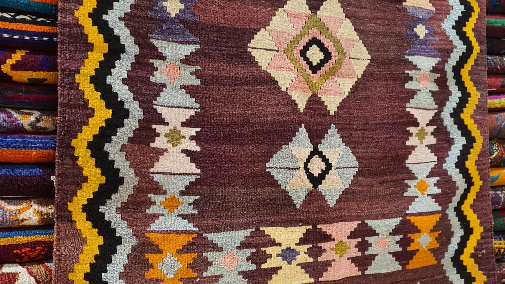 Vintage Handwoven Milas Kilim Rug, 4x5 ft, featuring a mocha mousse background with muted tones of rosewater pink, lavender mist, and tangerine peel. Adorned with intricate 'hair band' and 'running water' motifs, this artisan-crafted piece blends heritage and sophistication.