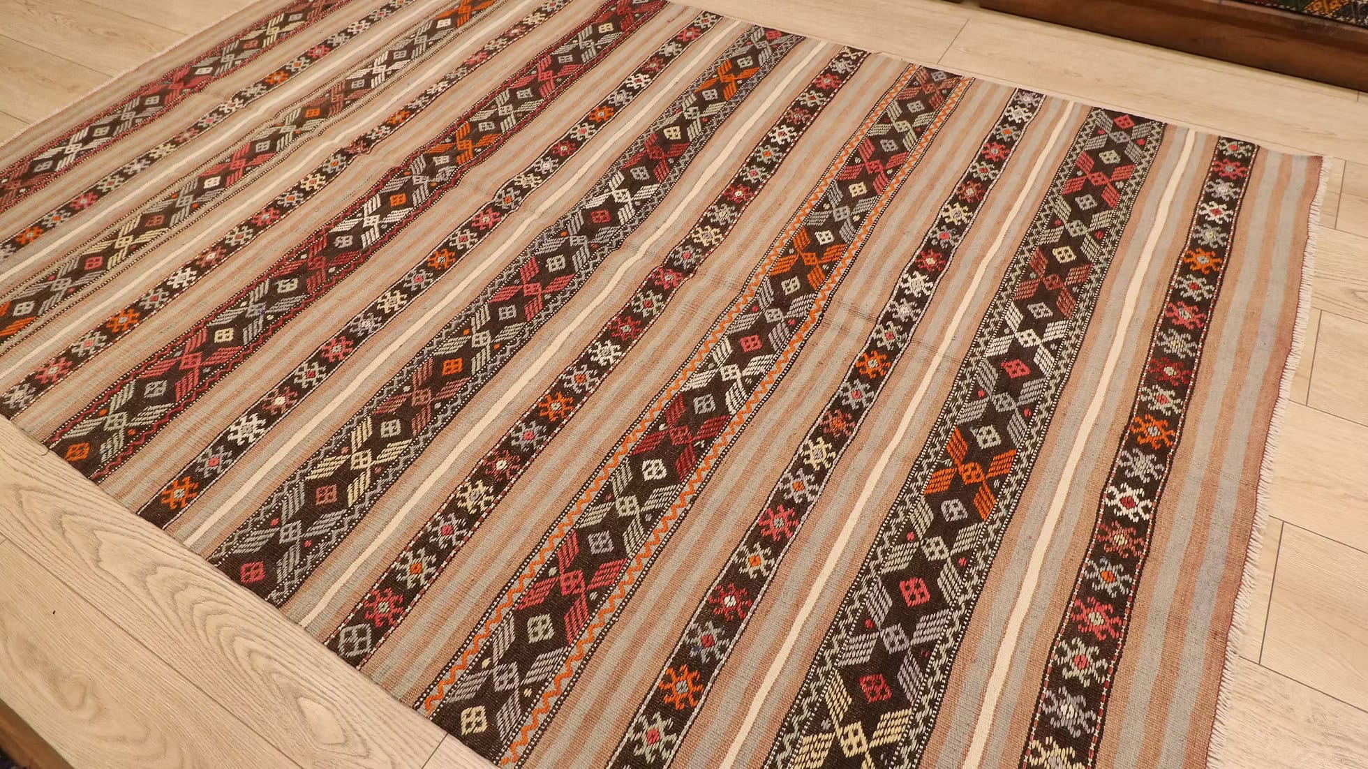 Shop Kilim Couture’s Vintage Turkish Kilim Rug from Balikesir. Handwoven by artisans in the 1950s, this mid-century rustic piece showcases traditional motifs, earthy colors, and timeless beauty.