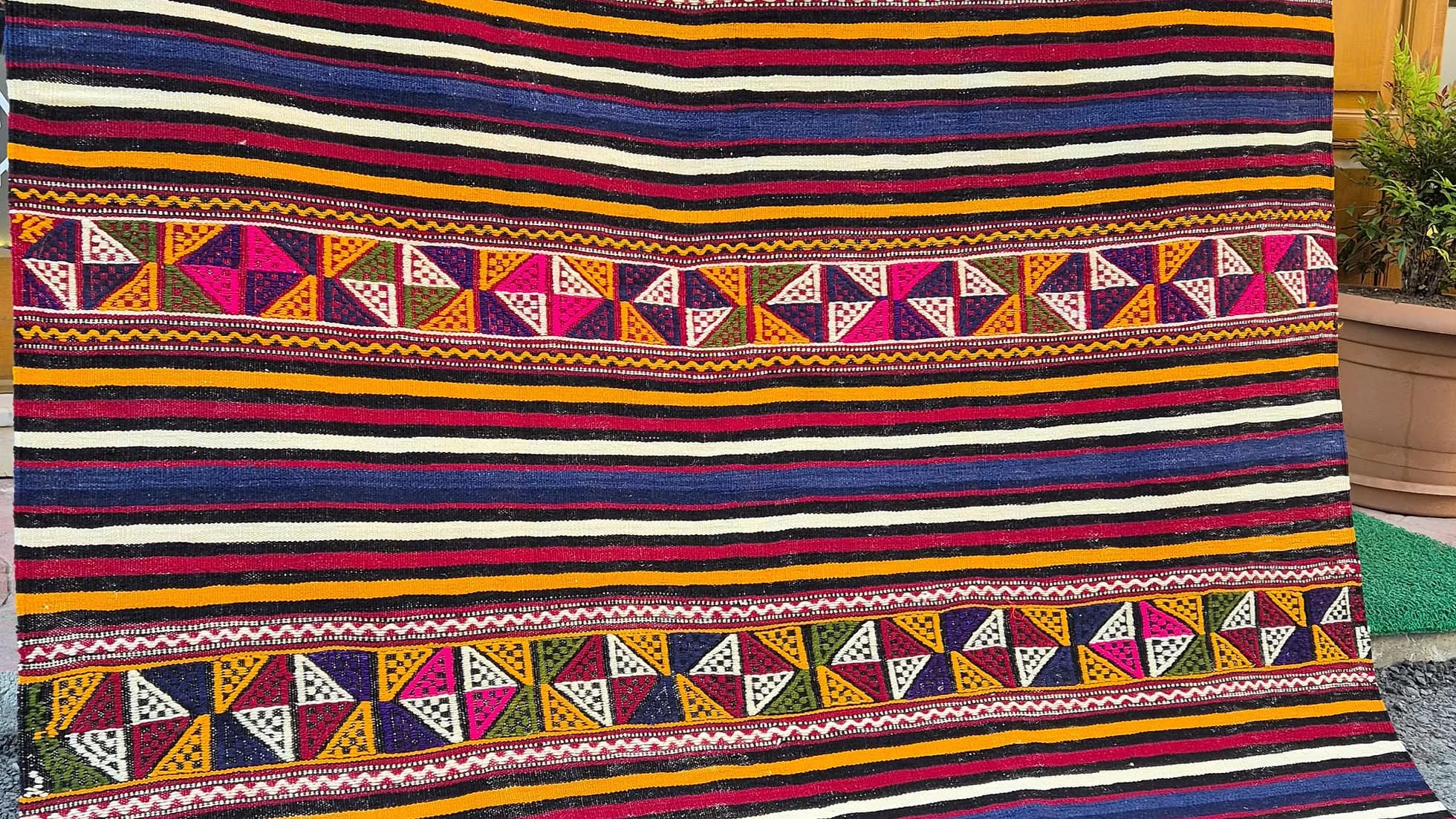 Close-up of a Turkish textile multicolor striped kilim rug highlighting traditional craftsmanship.