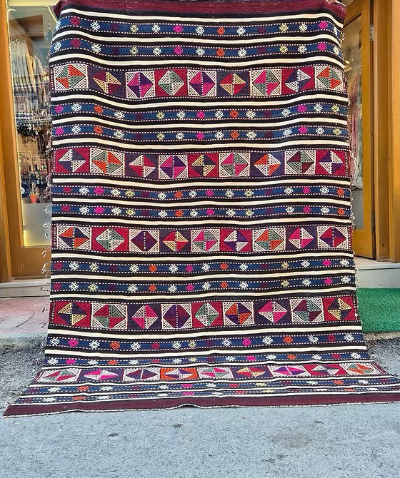Rustic Turkish kilim rug, 5x8 ft, with a rich palette of midnight indigo, maroon plum, and ivory.