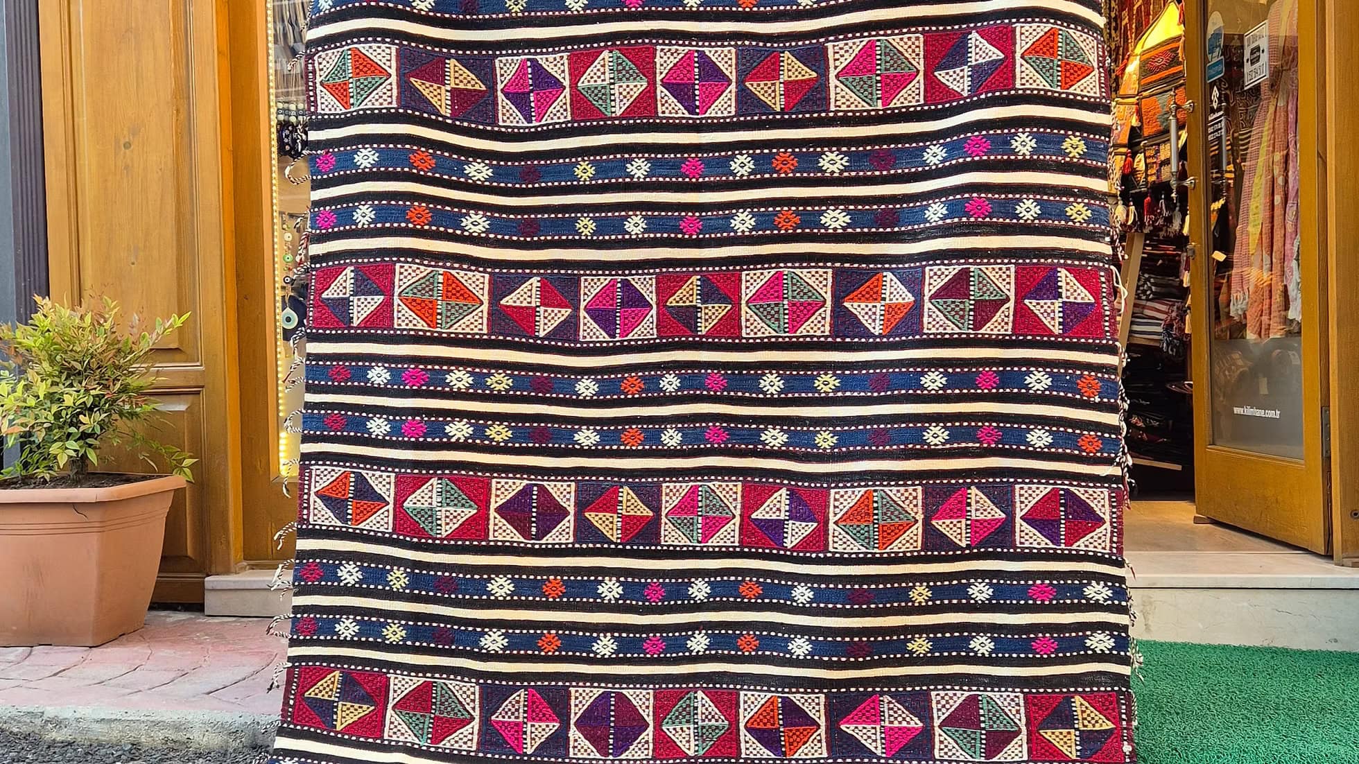 Handwoven Turkish kilim rug, 5x8 ft, featuring rare side tassels and vibrant stripes.
