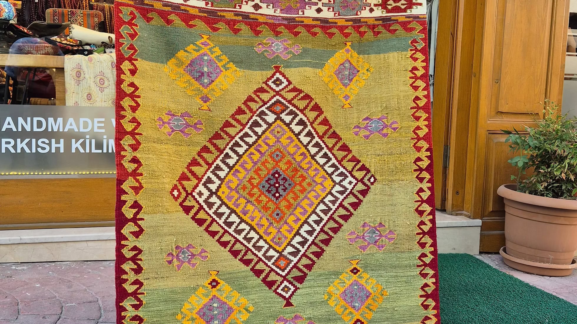 Mid-Century Turkish handwoven rug with soft colors, perfect for styled reading nooks and elegant spaces