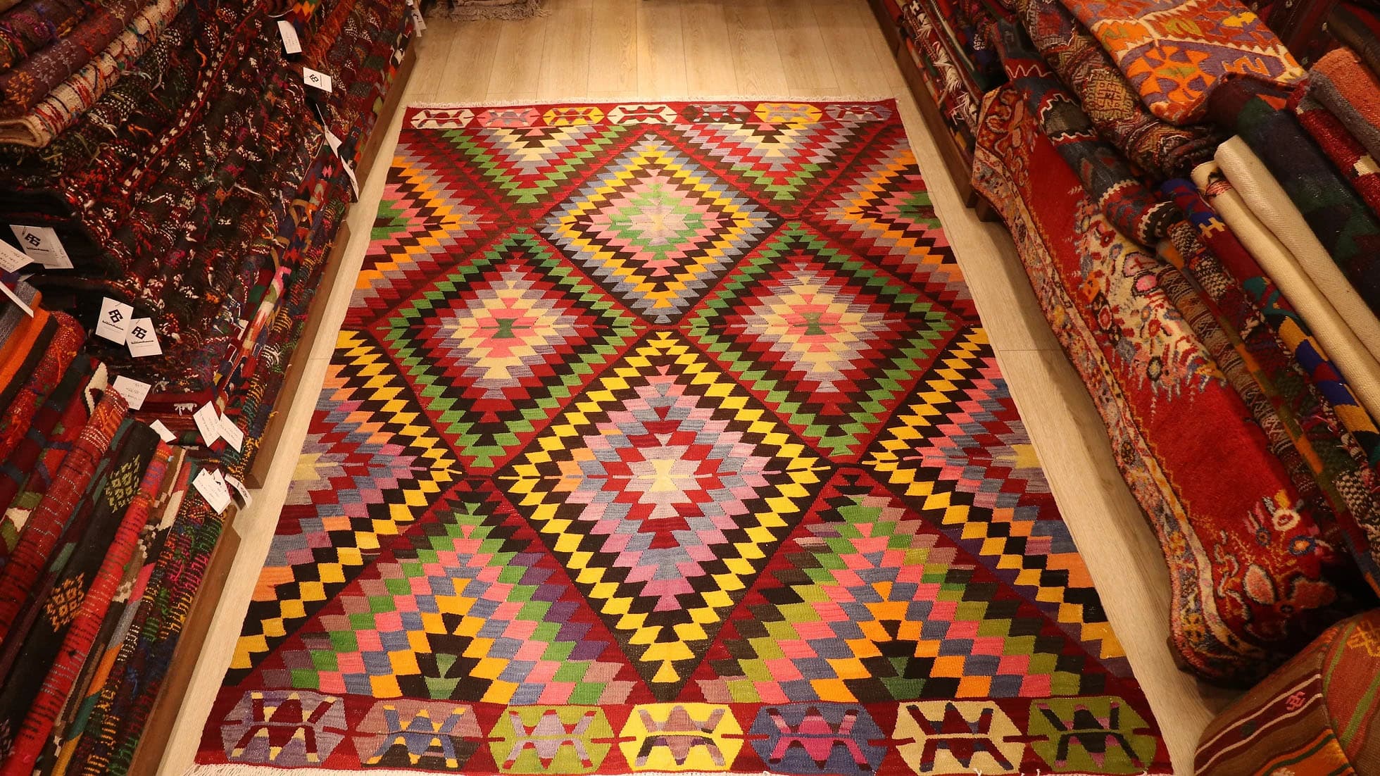 Vintage Turkish Handwoven Rug from Cal, Denizli, 6x8 ft kilim with vibrant crimson, emerald, lavender, and gold tones, featuring traditional motifs and eco-friendly craftsmanship.