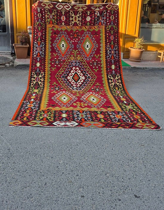 large sized handwoven Anatolian wool rug with central geometric medallion in red