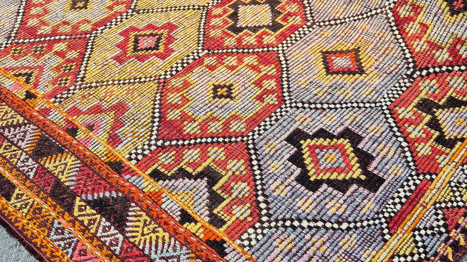 Close-up of a vintage Turkish Cecim kilim Rug in terracotta and denim tones—ideal for farmhouse interiors with rustic character.