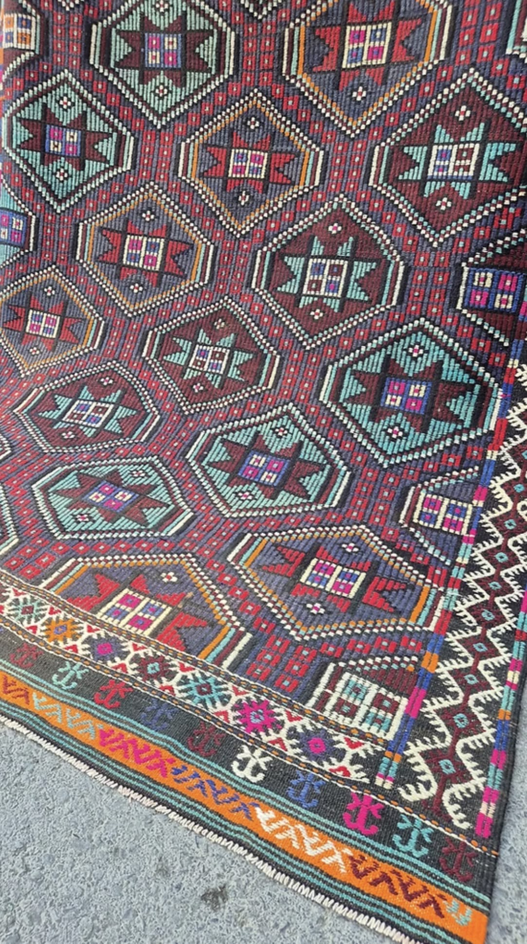 Close-up of a colorful geometric patterned Turkish tribal quilt rug