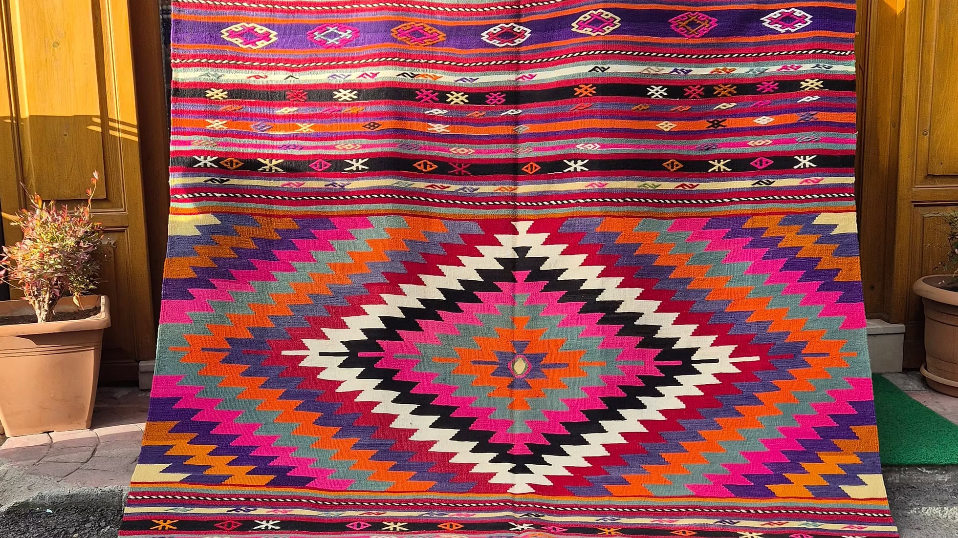 Vintage Turkish handwoven hybrid Manisa kilim with cecim bands in pink, 1960s–70s, featuring large diamonds and pastel accents