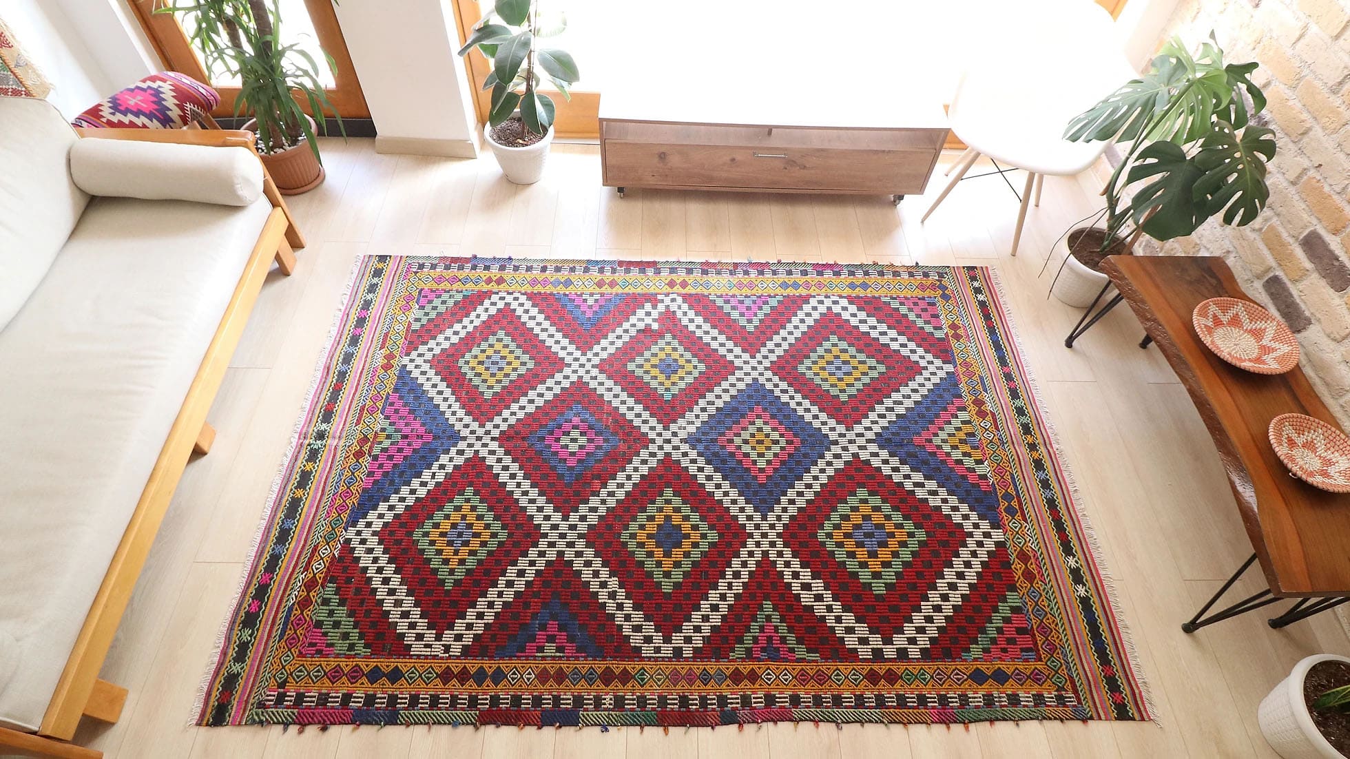 Vintage Manisa Cecim Rug, 6x9 ft. Handwoven in Turkey using intricate cecim techniques, this mid-century tribal kilim features vibrant lozenge patterns framed by striking borders. A rustic palette of crimson, indigo, yellow, and magenta makes it a versatile statement piece for eclectic or farmhouse interiors.