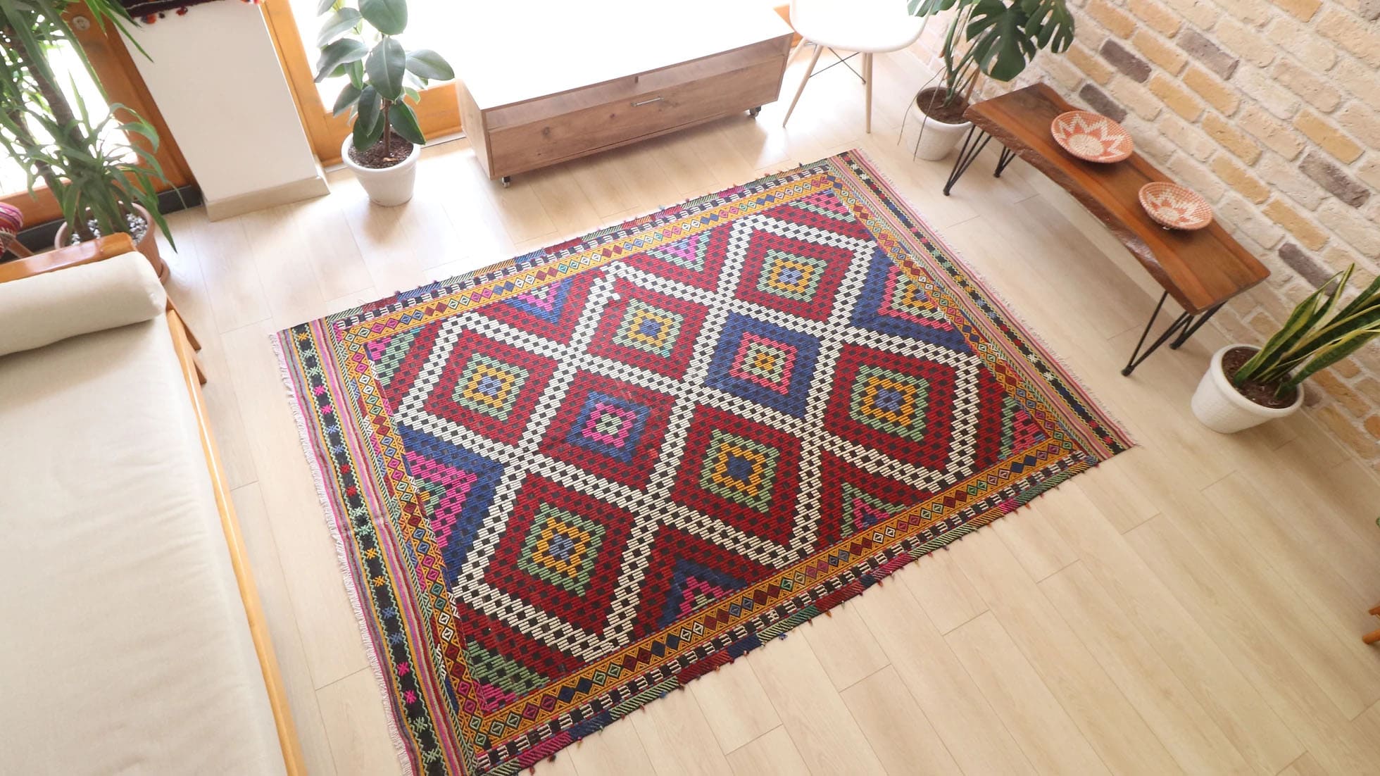 Vintage Manisa Cecim Rug, 6x9 ft. Handwoven in Turkey using intricate cecim techniques, this mid-century tribal kilim features vibrant lozenge patterns framed by striking borders. A rustic palette of crimson, indigo, yellow, and magenta makes it a versatile statement piece for eclectic or farmhouse interiors.