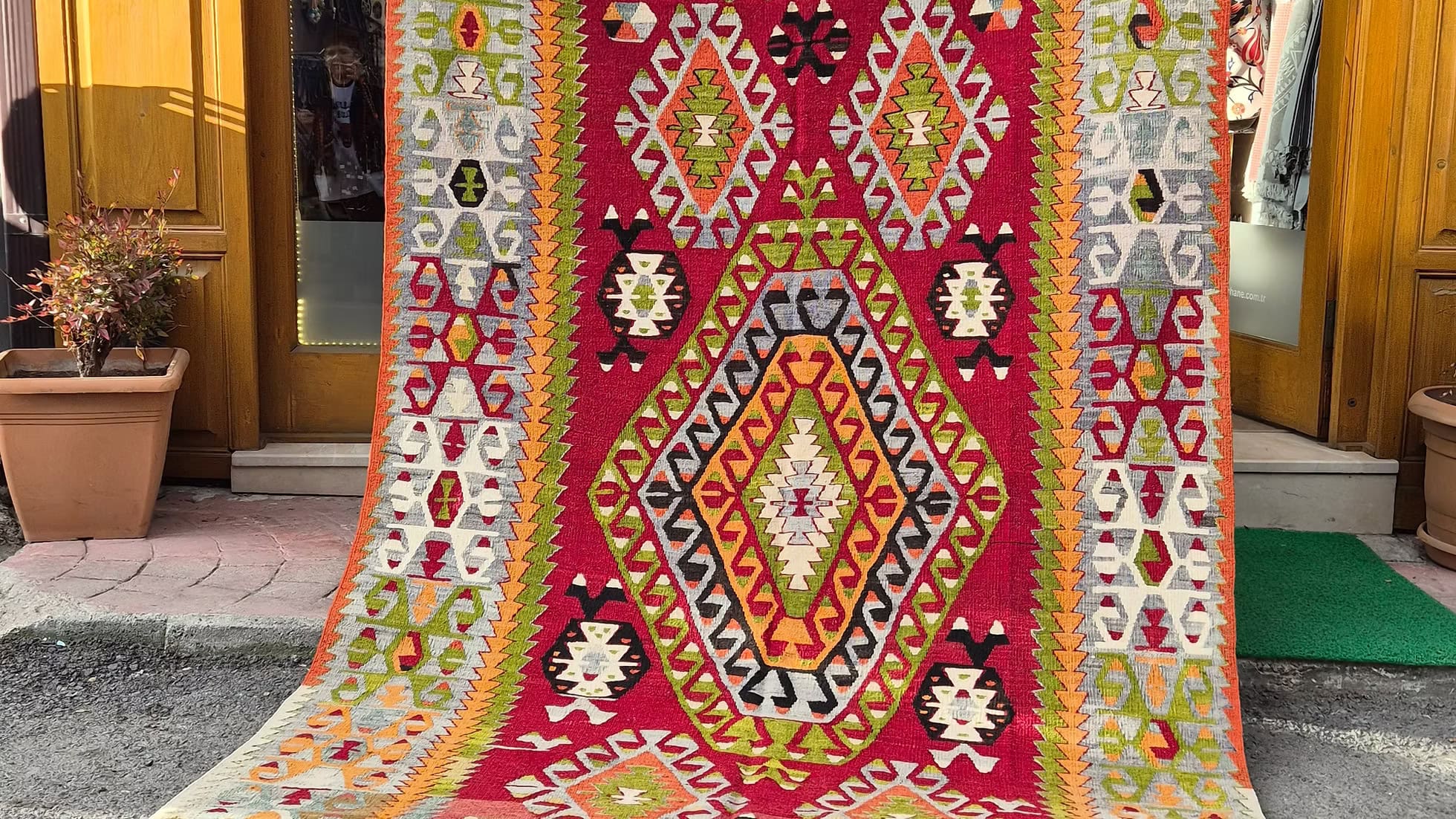 Vintage mid-century Turkish geometric kilim rug, 6x10 ft, handwoven with a bold tribal diamond medallion and naturally faded colors.
