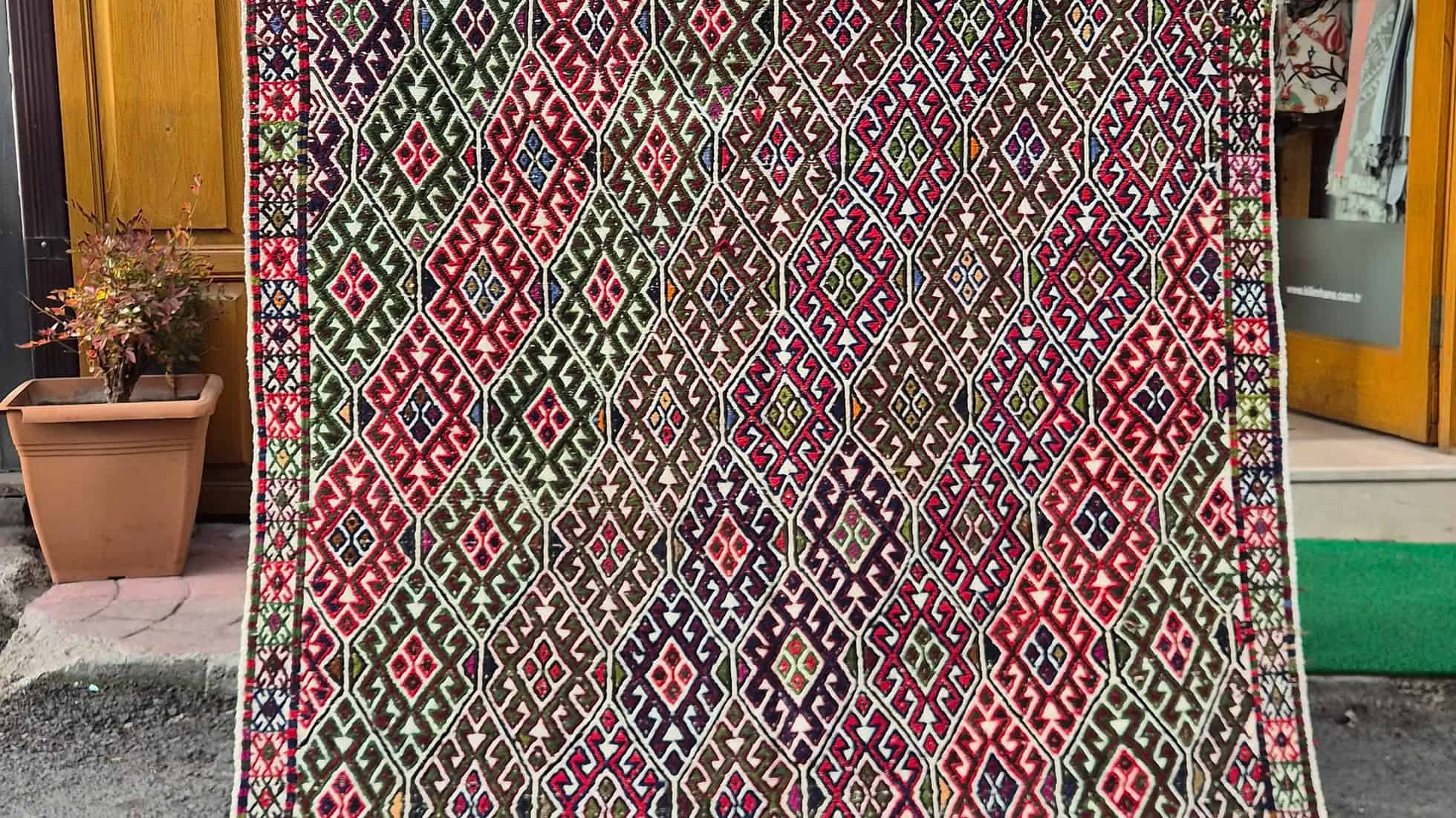 Vintage Turkish handwoven cecim kilim rug with raised tribal motifs on ivory ground by Kilim Couture New York