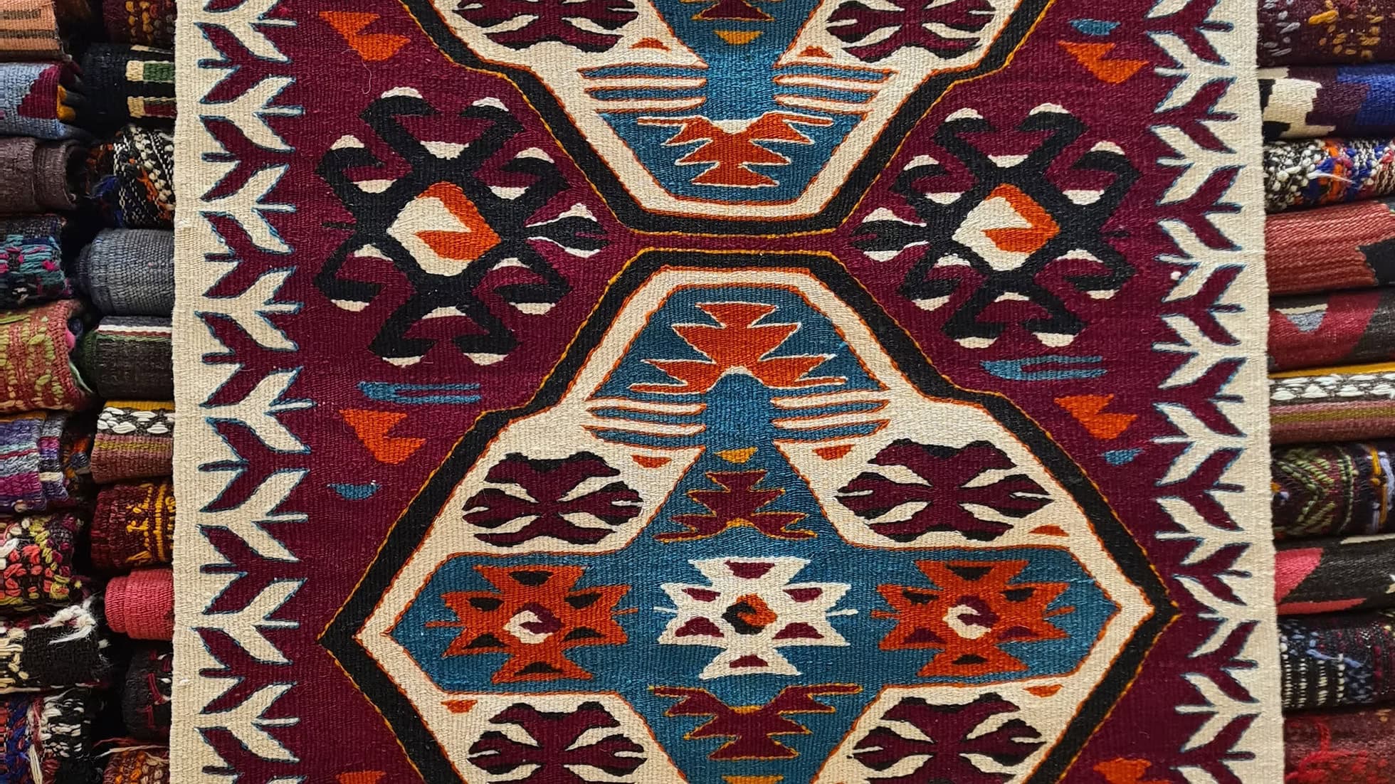 Vintage Anatolian kilim featuring bold medallions and symbolic motifs, including fertility and male vitality, handwoven over 50 years ago by tribal artisans