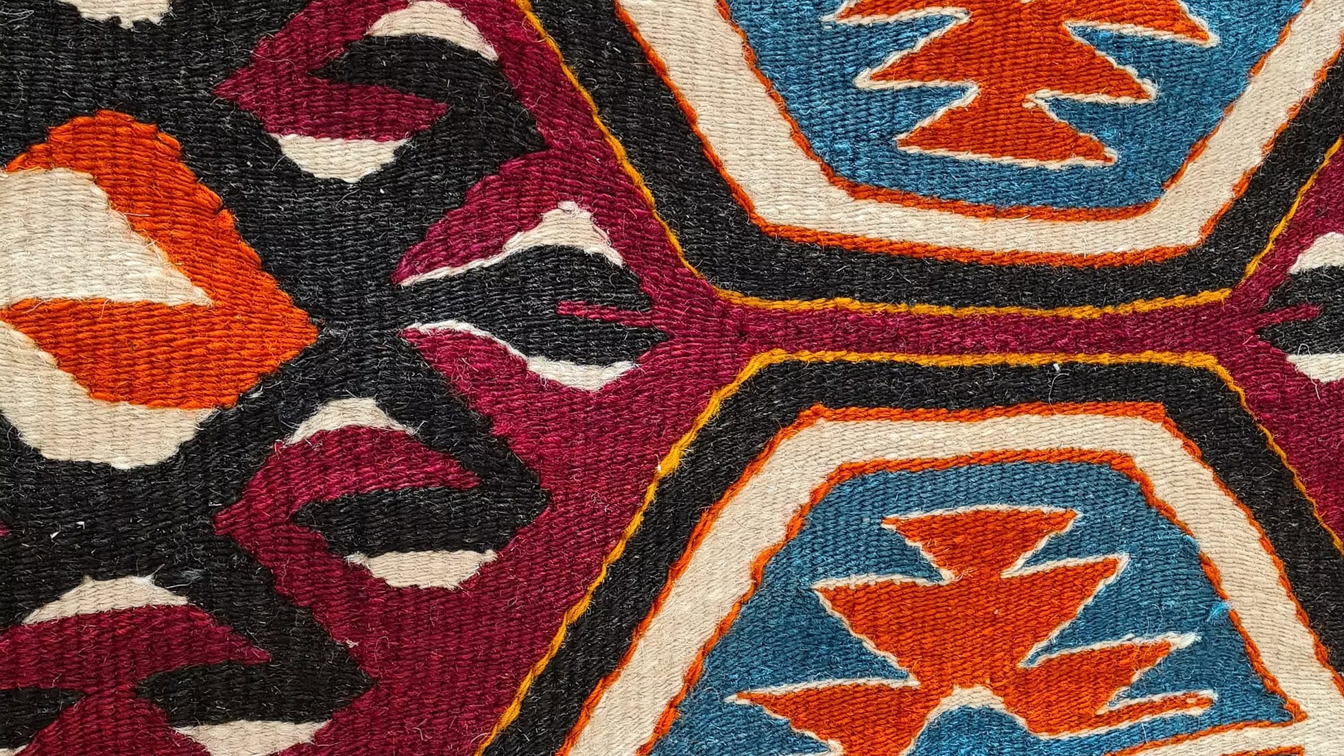 Vintage wool kilim with ancient geometric medallions, steeped in Turkish tradition, blending deep pomegranate, teal oxide, and ivory tones in a sophisticated design