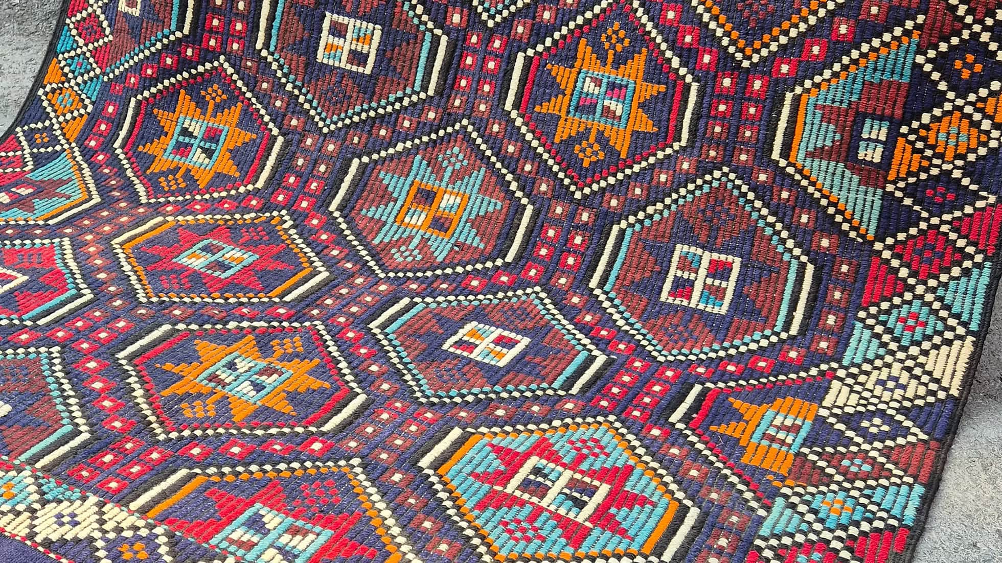 Mid-century modern vintage kilim rug with geometric star patterns and rich texture, ideal for curated layered interiors and maximalist living rooms