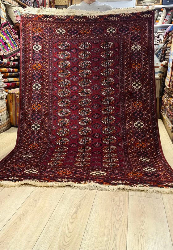 Mid-Century Bokhara Oriental Rug – Vintage Turkmen Handwoven Rug with Gul Medallions and a rich red color palette