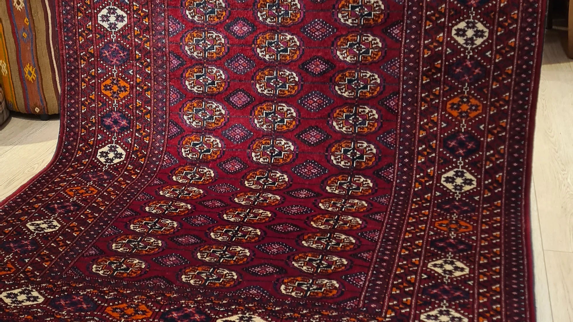 1960s Turkmen Bokhara Oriental Rug with Gul Medallions – Rich red and blush pink accents in a handwoven vintage piece, exclusively at Kilim Couture New York rug gallery