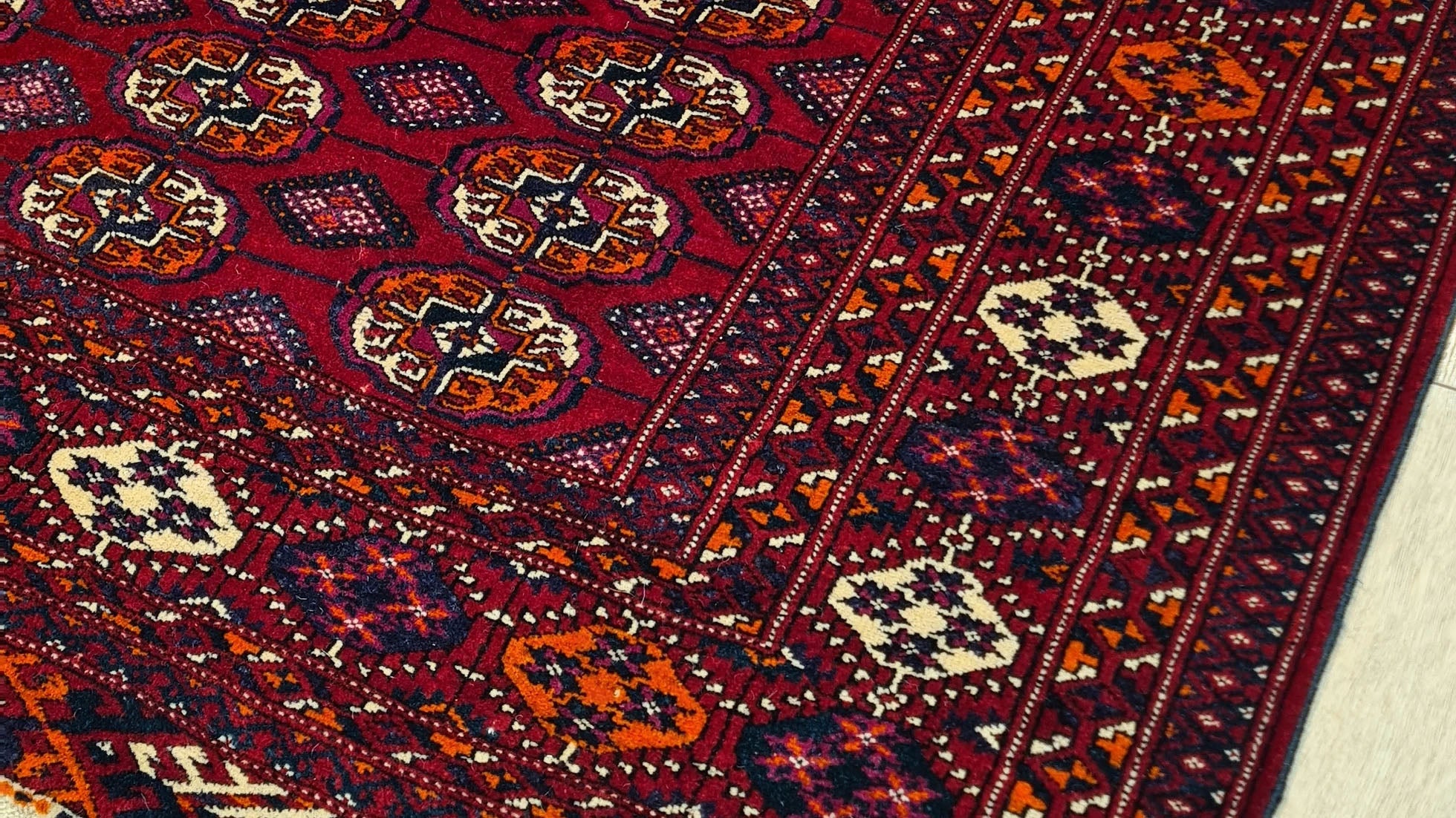 Vintage Turkmen Wool Bokhara Rug – Deep red and geometric medallion design from the 1960s